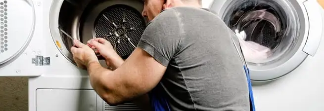 Dryer repair technician fixing a clothes dryer drum in Oakland, CA