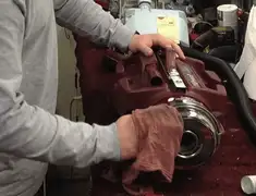 Vacuum repair technician cleaning and servicing a vacuum motor in Oakland, CA