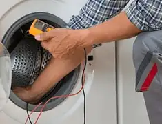 Washing machine repair technician testing a front-load washer with diagnostic tools in Oakland, CA